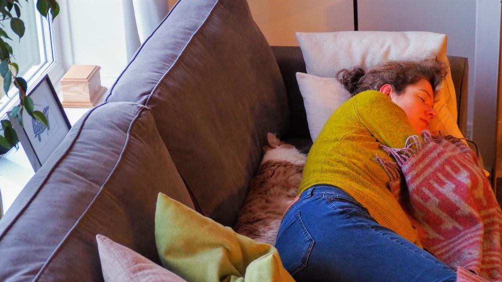 Joana sleeping on sofa with Henry.